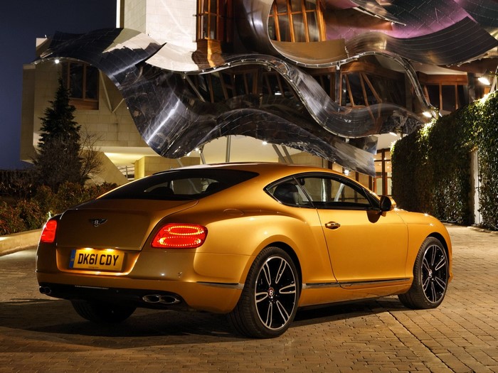 Bentley Continental GT parked in front of a modern building