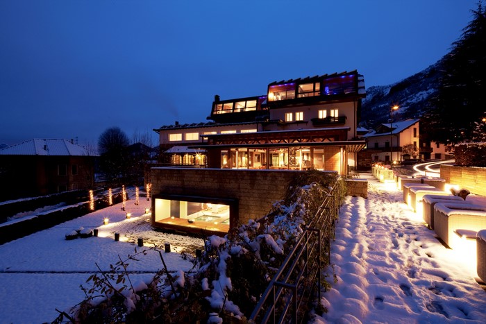 Modern hotel building in snowy Italy at dusk