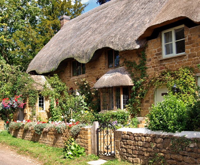 Thatched cottage with stone walls and garden in the UK