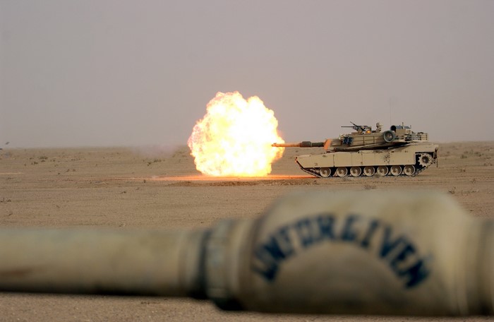 M1 Abrams tank firing in desert
