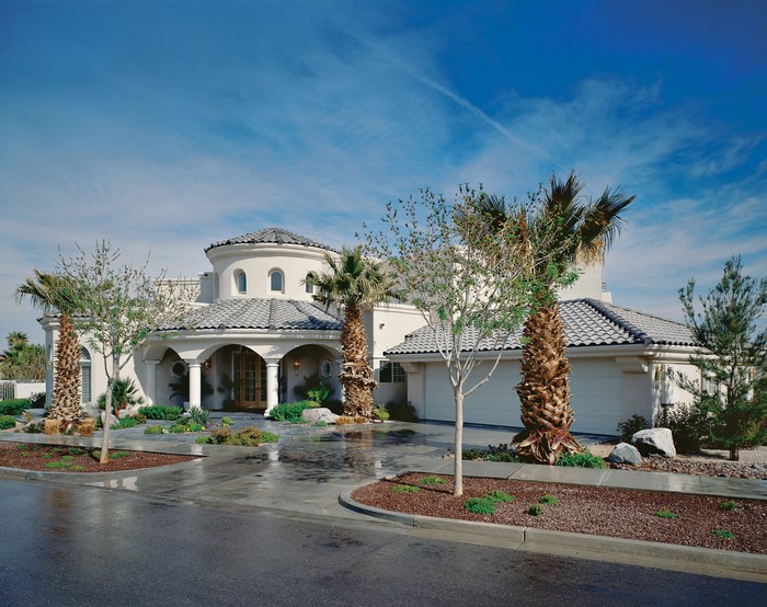 Mediterranean resort-style house with palm trees