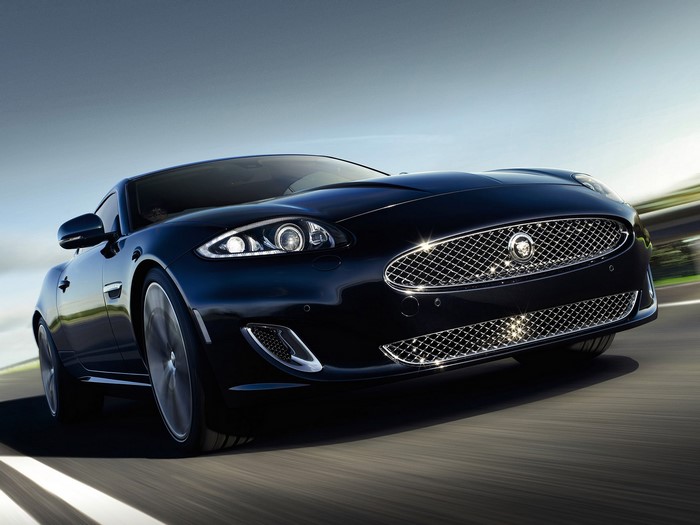 Black Jaguar car driving on a road