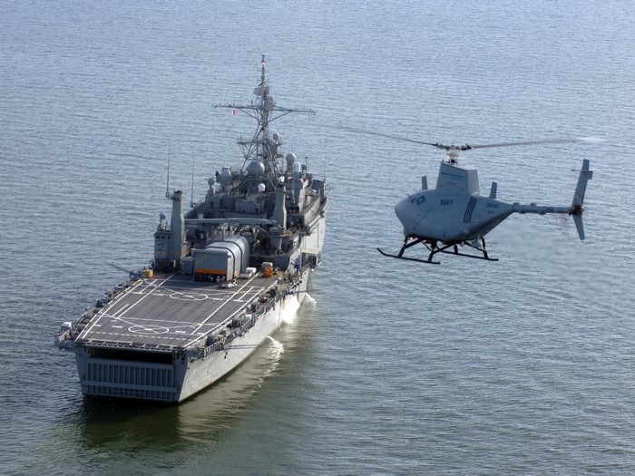 Unmanned helicopter flies near a Navy ship