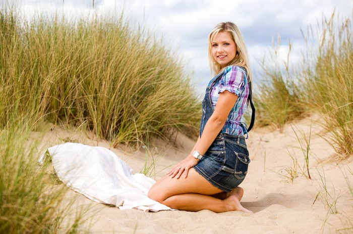Jenni Gregg on a sandy beach with tall grass