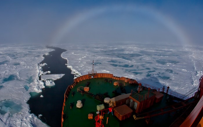 Ship navigating through ice with a sun halo