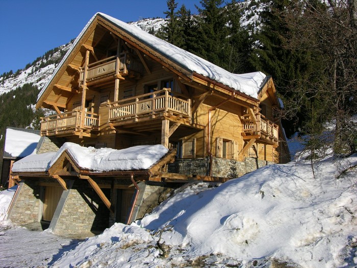 Wooden chalet in snowy mountains
