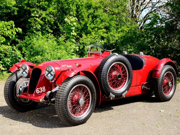 Red Aston Martin 1939 race car with spare tire