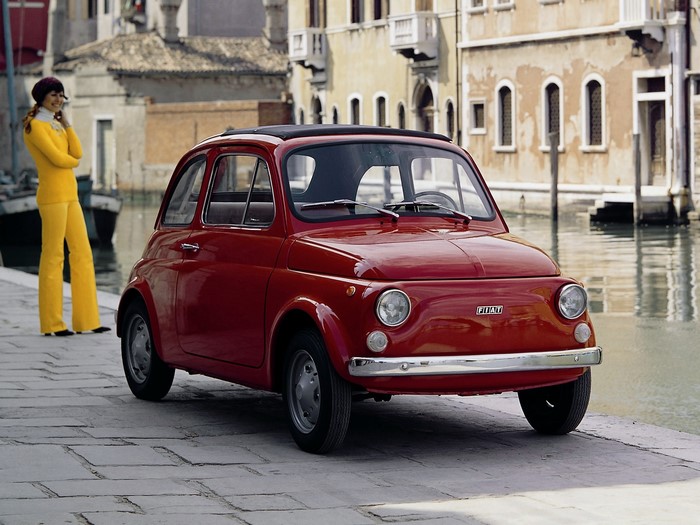 Red Fiat 500 R with a woman in yellow