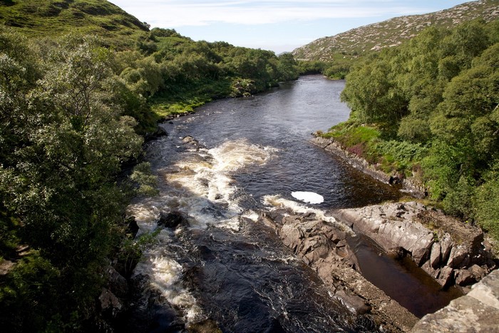 River flowing through a green, hilly landscape