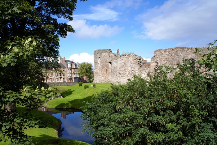 Rothesay Castle ruins with a moat and buildings