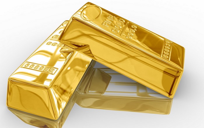 Two gold ingots on a reflective surface