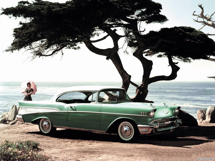 1957 Chevrolet Bel Air Sport Coupe with a woman holding an umbrella