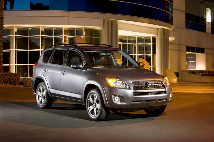 Silver Toyota RAV4 parked in front of a modern building