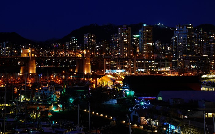 Vancouver cityscape with bridge and harbor at night