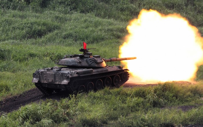 Tank firing a round with a large explosion