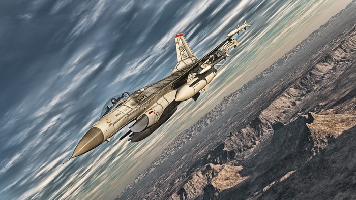 F-16 fighter jet flying over a mountainous landscape