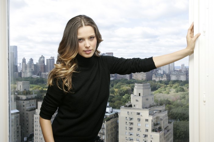 Petra Nemcova posing by a window overlooking a city