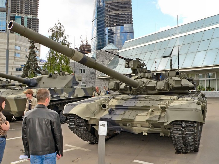 T-90 tanks on display with modern buildings