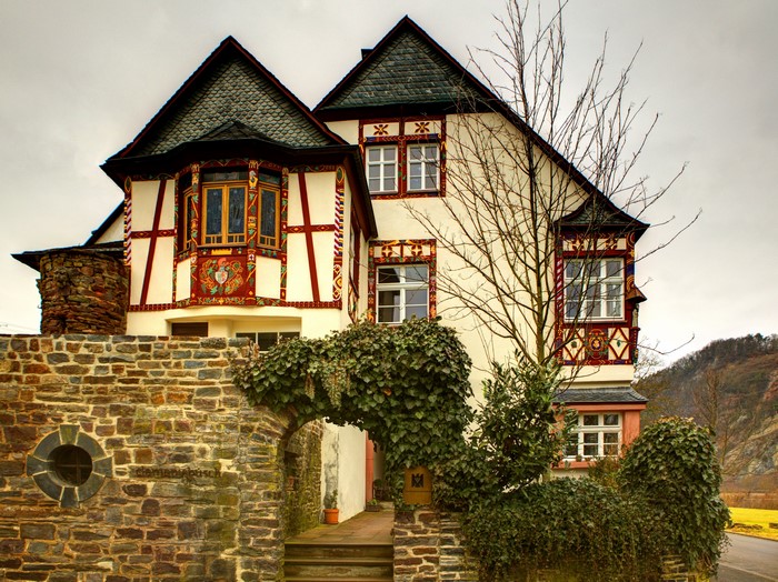 Half-timbered house with stone wall and archway in Germany