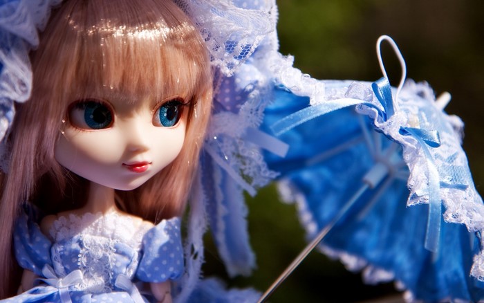 Doll in blue dress with white lace and umbrella