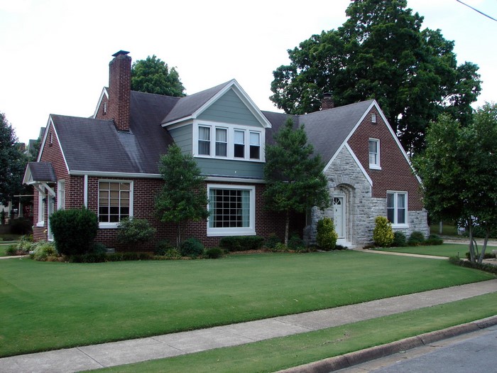Brick and stone house with lawn in USA