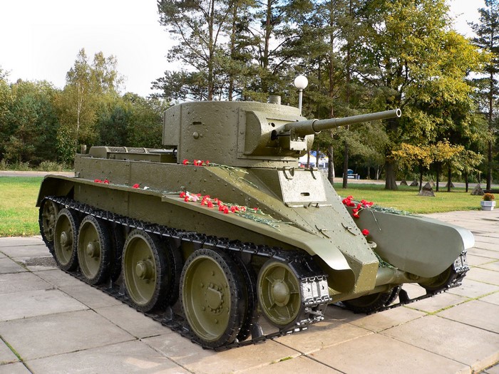 Soviet BT-7 tank monument with red flowers