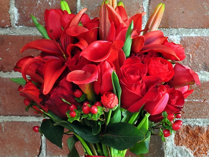 Red flower bouquet with brick background
