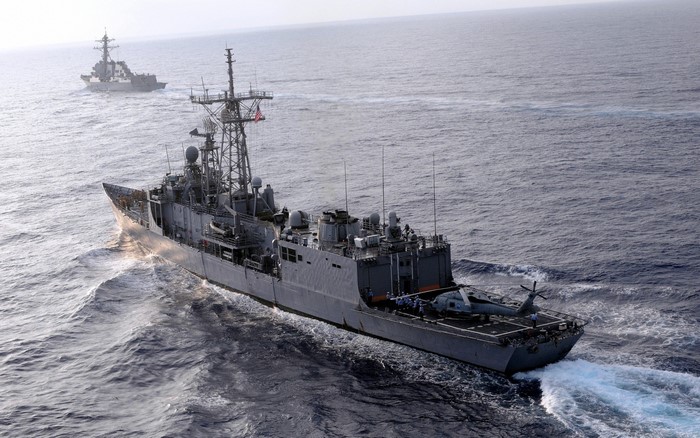 Two US Navy ships sailing on the ocean