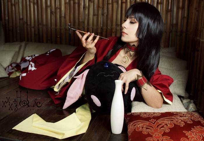 Woman in red kimono holding a pipe