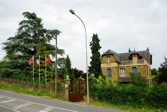 House with flags and trees in France