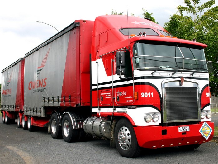 Kenworth K100E truck with Owens Global Logistics trailers