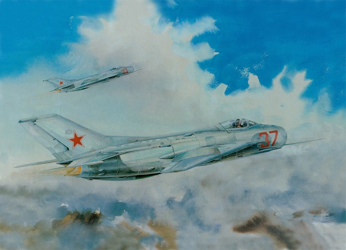 Two Soviet MiG-17 fighter jets flying through clouds