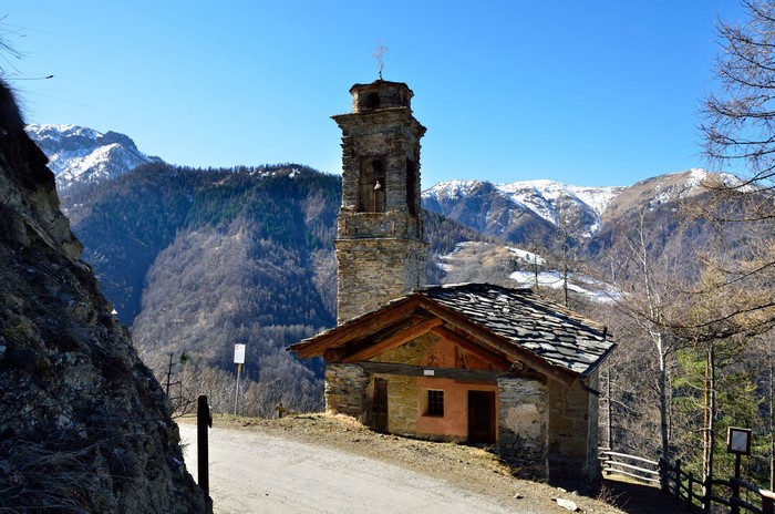 Stone church with bell tower in Italian Alps