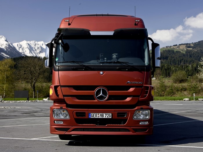 Mercedes-Benz Actros truck in a parking lot with mountains