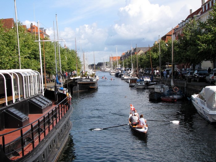 Canal in Copenhagen, Denmark with boats and people rowing