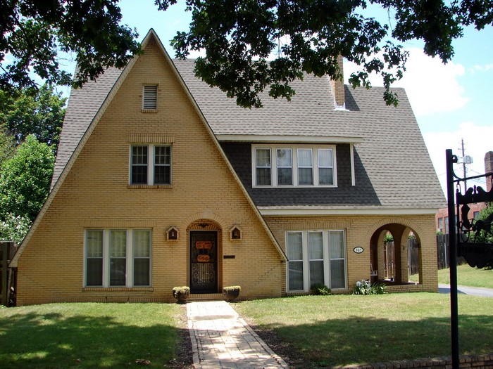 Yellow brick house with arched entryway in USA