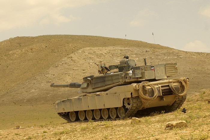 M1 Abrams tank in a desert landscape