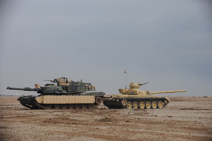 Two tanks in a desert landscape