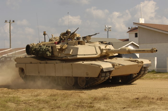 M1 Abrams tank with crew in desert environment
