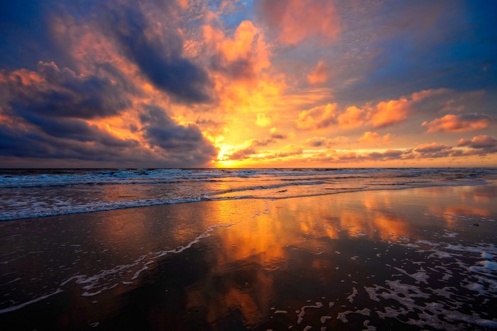 Sunset over the ocean with dramatic clouds