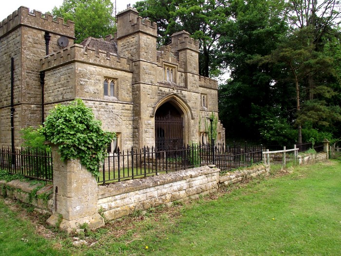 Stone gatehouse with crenellated towers and arched entrance