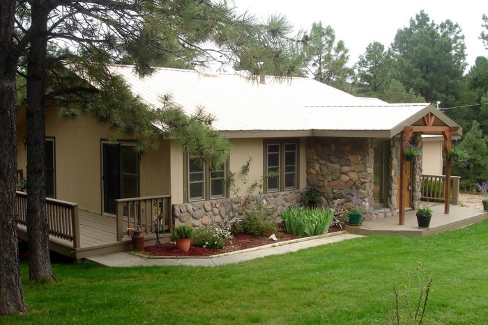 House with stone facade and wooden deck