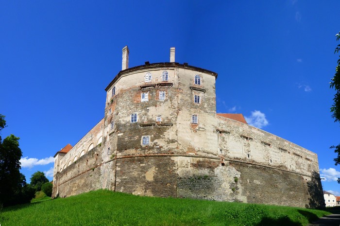 Castle on a grassy hill under a blue sky