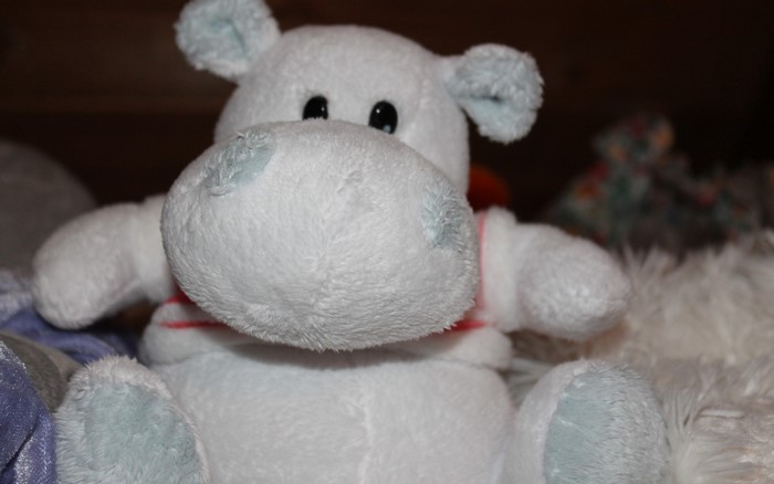 White plush hippo toy with blue ears