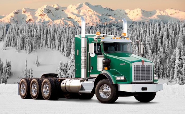Green Kenworth Truck in Snowy Mountains