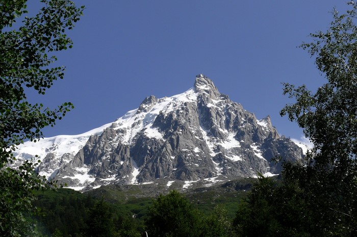 Snow-capped mountain peak against a clear blue sky