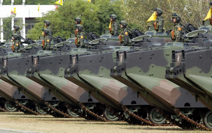 Soldiers in armored vehicles in a parade