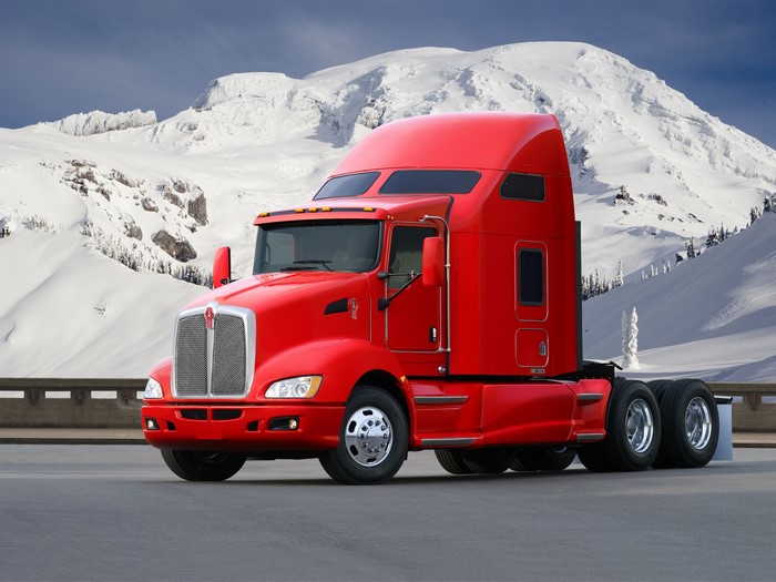 Red Kenworth Semi-Truck in Snowy Mountains