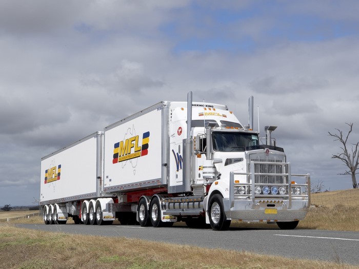 White Kenworth truck with MFL trailers on a road
