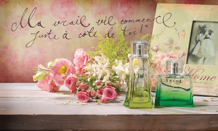 Perfume bottles with flowers and photo frame